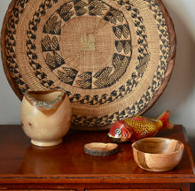 Load image into Gallery viewer, A set of three wooden bowls of different sizes on a wooden table with a metal carp childrens toy and a large round African basket in the background