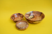 Load image into Gallery viewer, Three wooden bowls of varying sizes on a yellow background.
