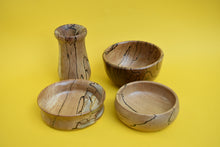 Load image into Gallery viewer, Four hand-turned wooden items. Three bowls and one vase. There is a yellow background.