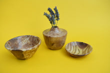 Load image into Gallery viewer, A wooden bowl, a small wooden dish and a wooden vase with dried lavender inside on a yellow background. 
