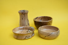 Load image into Gallery viewer, Four stylish wooden bowls on a yellow background. 
