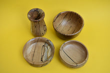 Load image into Gallery viewer, Birds eye view of four hand-turned beautiful bowls with a uniques pattern on a yellow background. 
