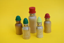 Load image into Gallery viewer, Five wooden peg people with different coloured hats and of differing heights on a yellow background.
