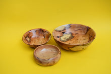 Load image into Gallery viewer, Three wooden bowls of varying sizes on a yellow background.
